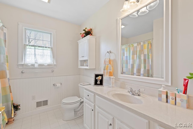 5225 Bent Oak Hwy, Adrian, MI 49221 - bathroom with toilet, a wainscoted wall, visible vents, tile patterned flooring, and vanity