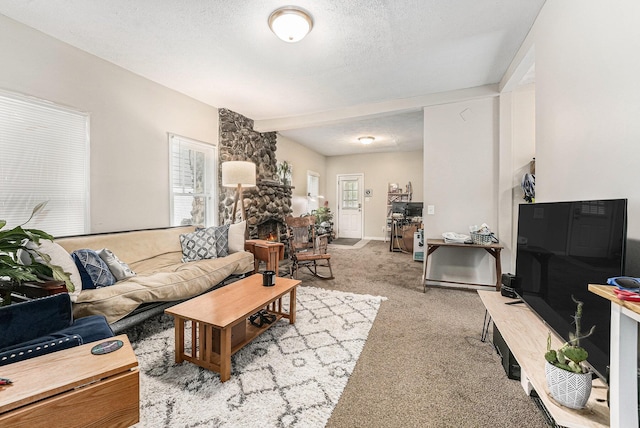 living area featuring a textured ceiling and carpet