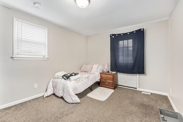 bedroom featuring carpet and baseboards