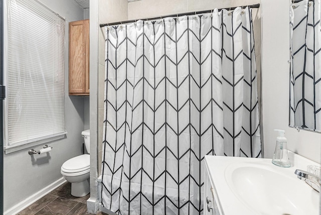 bathroom featuring vanity, toilet, a shower with curtain, and baseboards