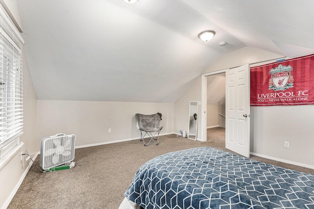 carpeted bedroom with baseboards and vaulted ceiling