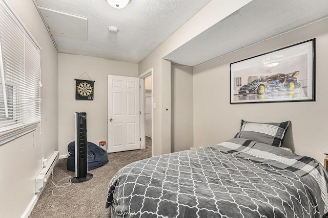 carpeted bedroom featuring a baseboard radiator, a textured ceiling, and baseboards