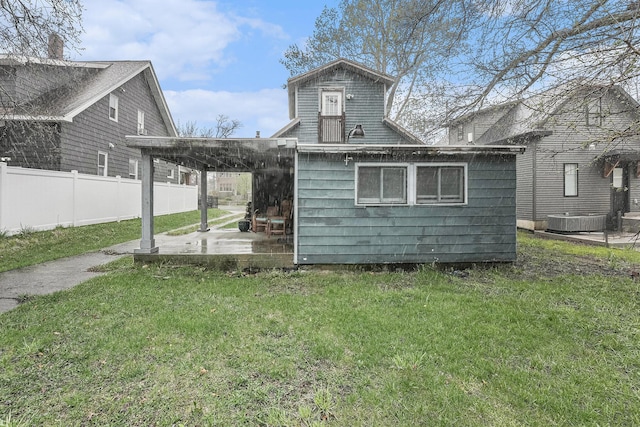 rear view of property with a yard, a patio area, and fence
