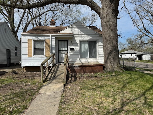 19511 Biltmore St, Detroit, MI 48235 - shotgun-style home with a chimney and a front lawn