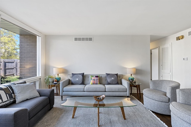 living room with visible vents and wood finished floors