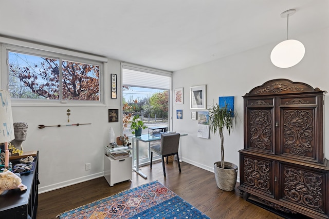 office area with dark wood-style flooring and baseboards