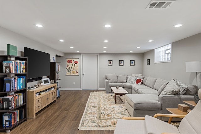 living room with visible vents, dark wood-style flooring, and recessed lighting