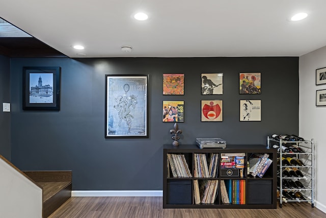 interior space with baseboards, recessed lighting, and wood finished floors