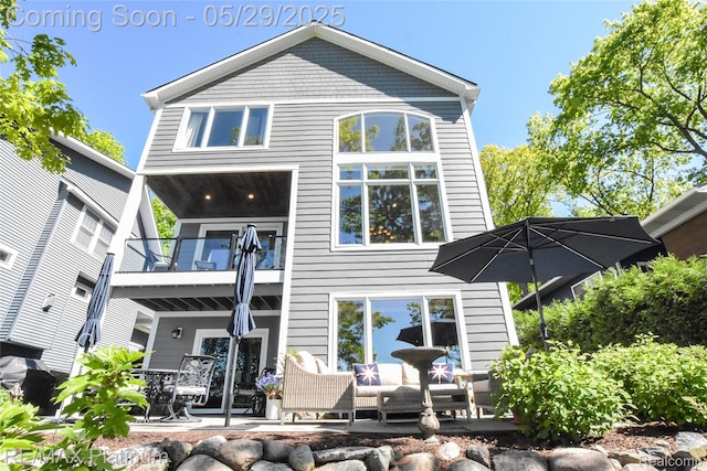 841 Hurley Dr, Howell, MI 48843 - back of property with a balcony and a patio