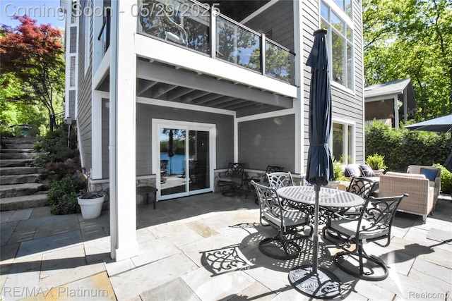 841 Hurley Dr, Howell, MI 48843 - view of patio featuring outdoor dining space, an outdoor hangout area, and stairway