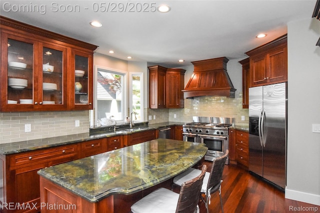 841 Hurley Dr, Howell, MI 48843 - kitchen with stainless steel appliances, premium range hood, a sink, recessed lighting, and dark wood-style flooring