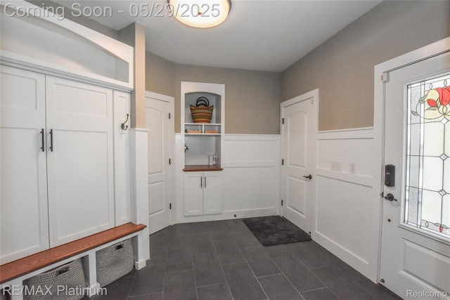 841 Hurley Dr, Howell, MI 48843 - mudroom featuring wainscoting, plenty of natural light, dark tile patterned flooring, and a decorative wall