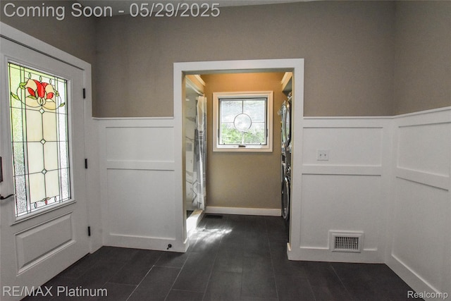 841 Hurley Dr, Howell, MI 48843 - entryway featuring a decorative wall, wainscoting, and dark tile patterned flooring