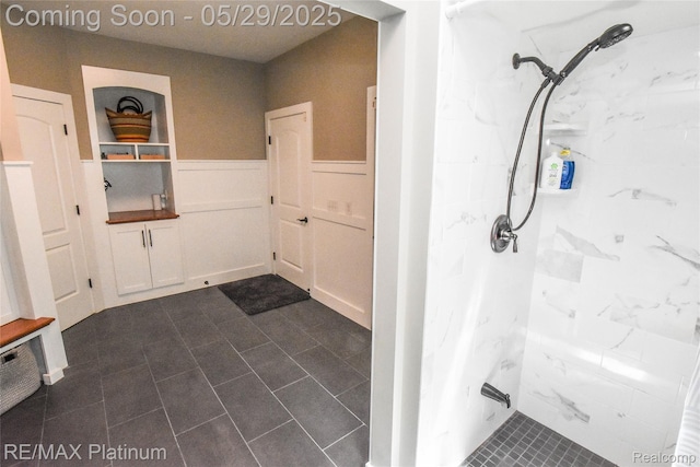 841 Hurley Dr, Howell, MI 48843 - bathroom featuring a marble finish shower and a wainscoted wall