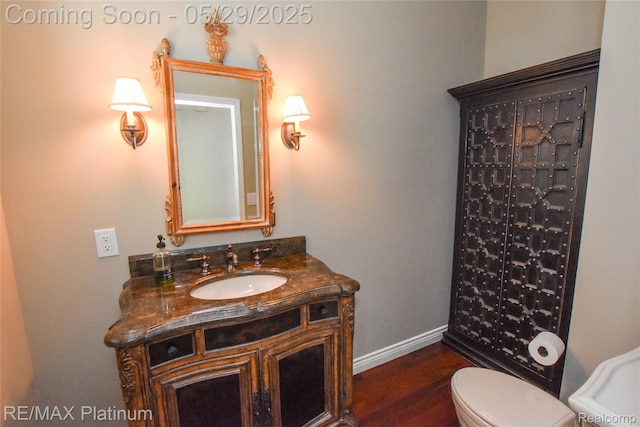 841 Hurley Dr, Howell, MI 48843 - full bathroom featuring vanity, baseboards, toilet, and wood finished floors