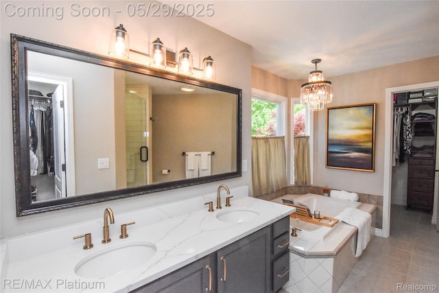 841 Hurley Dr, Howell, MI 48843 - bathroom featuring double vanity, a bath, a walk in closet, tile patterned floors, and a stall shower