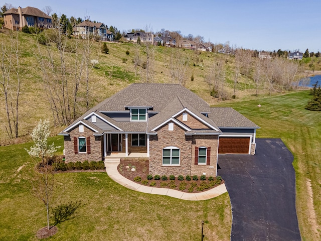craftsman house featuring stone siding, roof with shingles, and a front yard