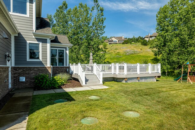 view of yard with a playground and a deck
