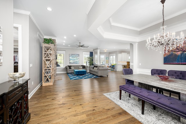 living room with crown molding, light wood-style flooring, recessed lighting, and ceiling fan with notable chandelier