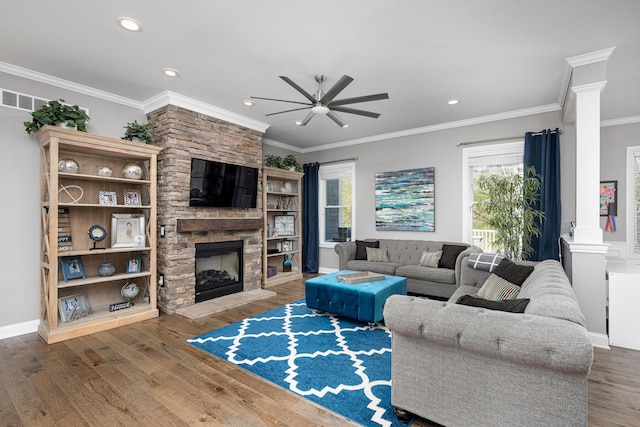 living area featuring a ceiling fan, a healthy amount of sunlight, and decorative columns