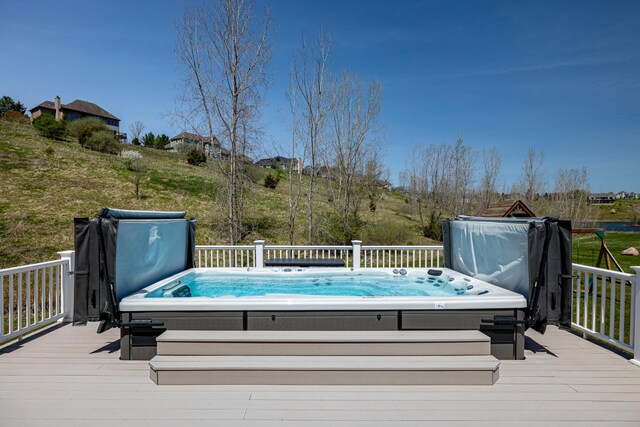 wooden deck featuring a covered hot tub