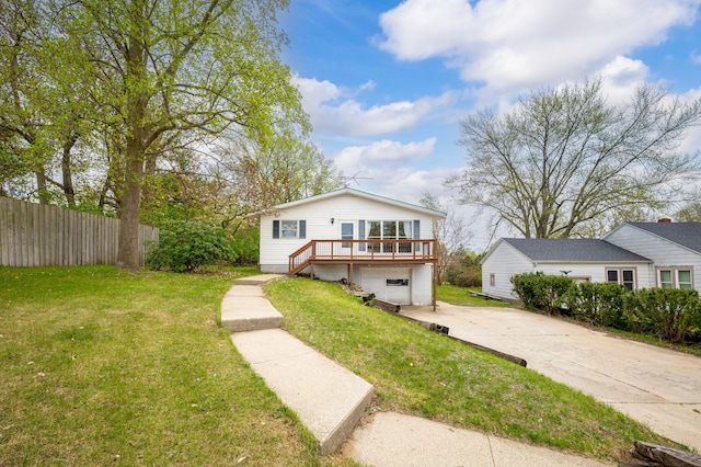 bungalow-style home featuring concrete driveway, a garage, fence, and a front yard