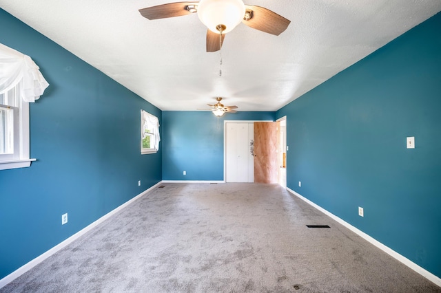 unfurnished bedroom with a ceiling fan, a closet, carpet floors, visible vents, and baseboards