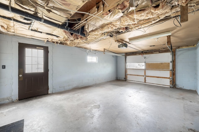 garage with concrete block wall and a garage door opener