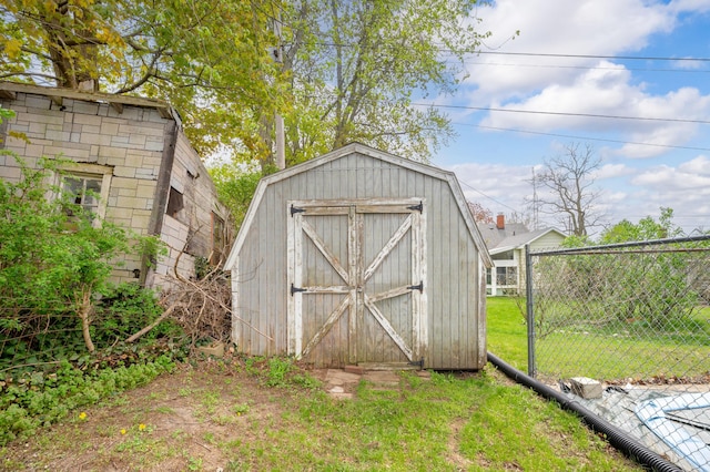 view of shed featuring fence