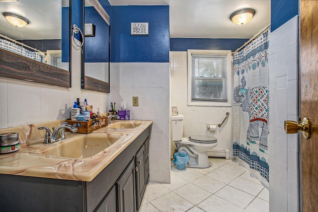 full bathroom featuring a sink, a baseboard radiator, toilet, and tile patterned floors