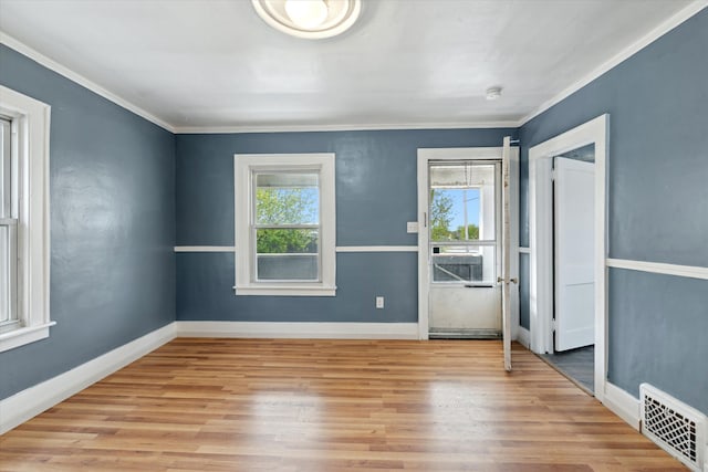 interior space featuring crown molding, visible vents, and wood finished floors