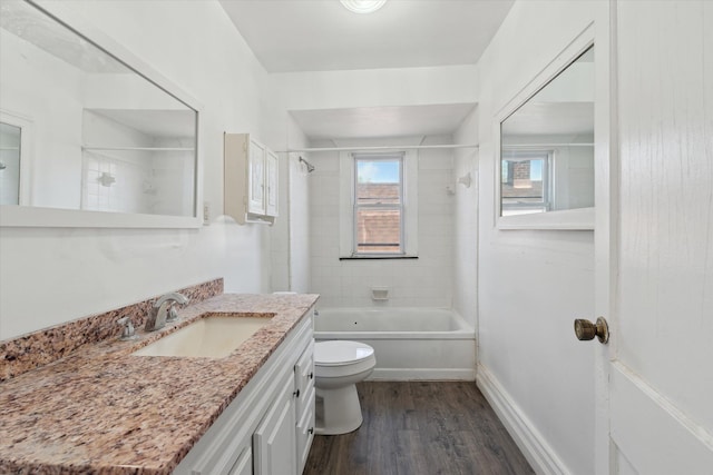 bathroom featuring shower / bathing tub combination, vanity, toilet, and wood finished floors