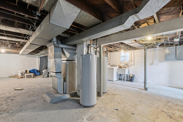 below grade area featuring gas water heater, washer / clothes dryer, electric panel, and water heater
