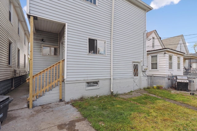 view of home's exterior with a yard and fence