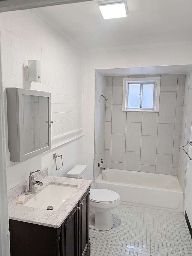 bathroom featuring tile patterned floors, toilet,  shower combination, and vanity