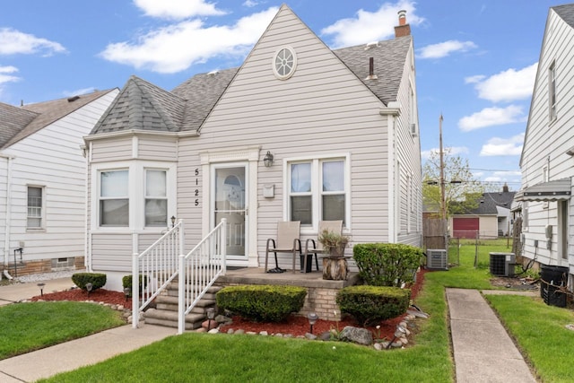 5125 Curtis St, Dearborn, MI 48126 - view of front facade with a shingled roof, a chimney, and central AC