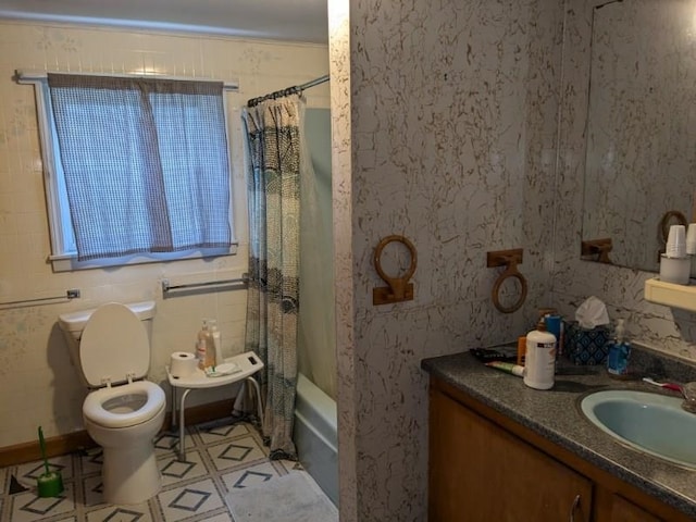 bathroom with toilet, vanity, and shower / bath combo with shower curtain