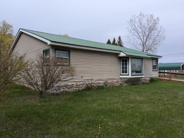view of side of property with metal roof