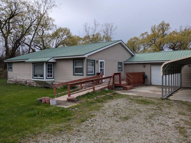 view of front facade featuring metal roof, a front yard, an attached garage, and a deck
