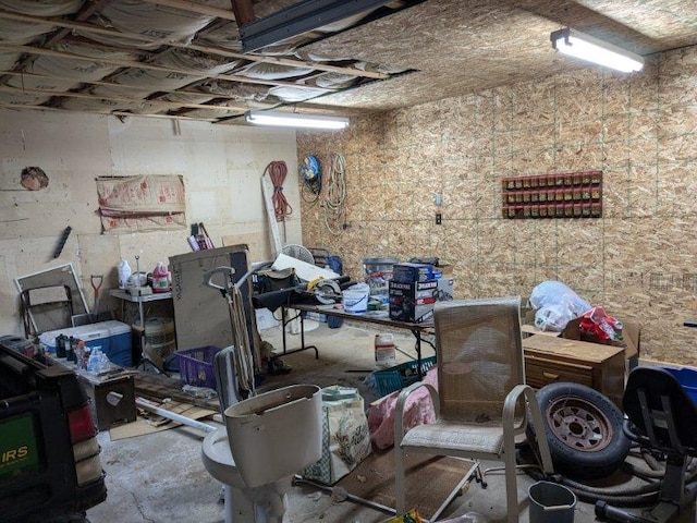 miscellaneous room with unfinished concrete flooring