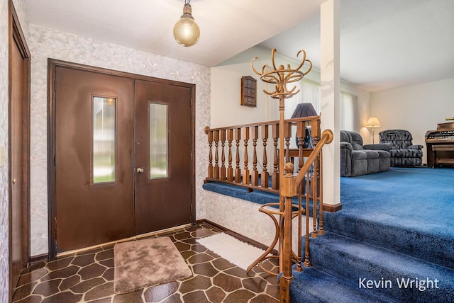 entryway with baseboards and wallpapered walls