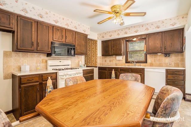 kitchen with white appliances, ceiling fan, a sink, decorative backsplash, and light countertops