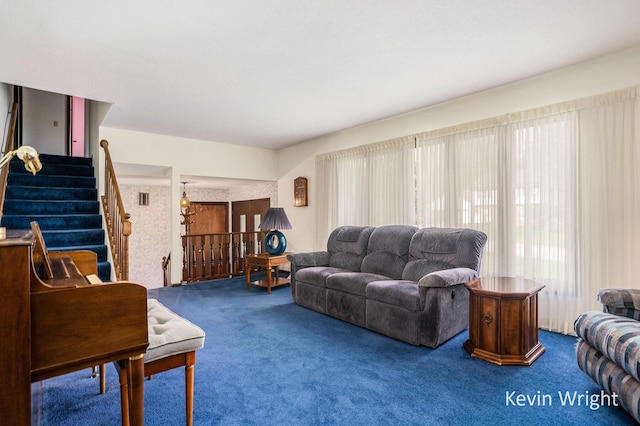 living area with carpet and stairs