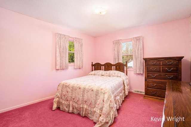 carpeted bedroom featuring baseboards and visible vents