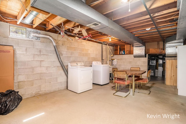 below grade area featuring visible vents and washer and clothes dryer