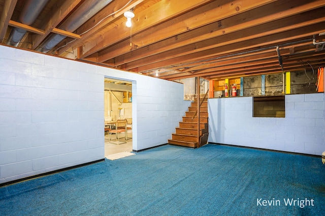 unfinished below grade area featuring carpet flooring and stairs