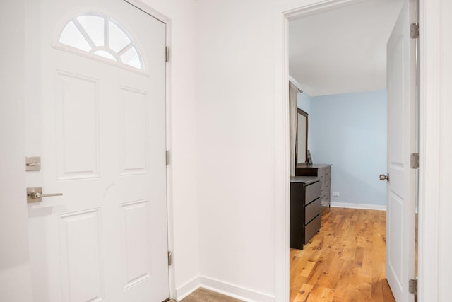 entryway featuring light wood-style floors and baseboards