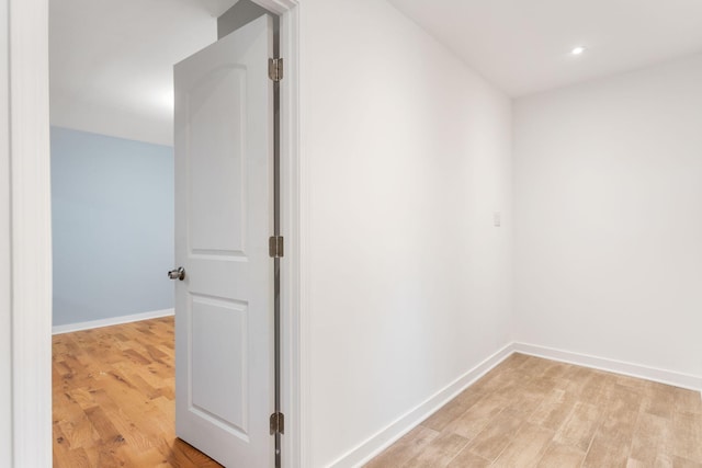 corridor with recessed lighting, baseboards, and light wood-style floors