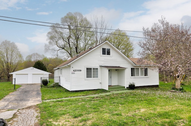 bungalow featuring an outdoor structure, a front yard, and a detached garage