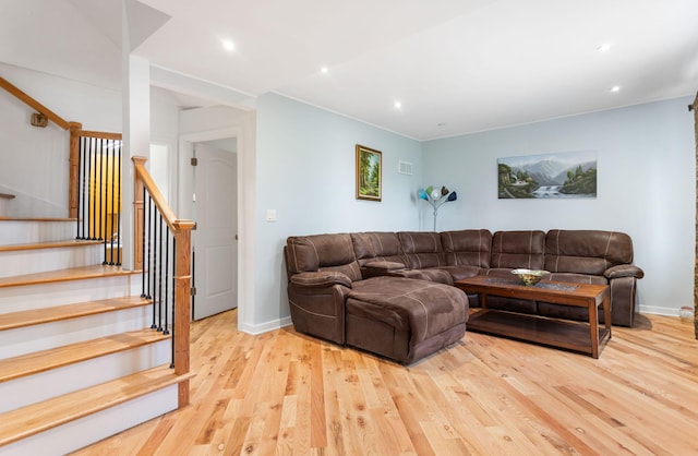 living room with visible vents, recessed lighting, stairway, baseboards, and light wood-style floors